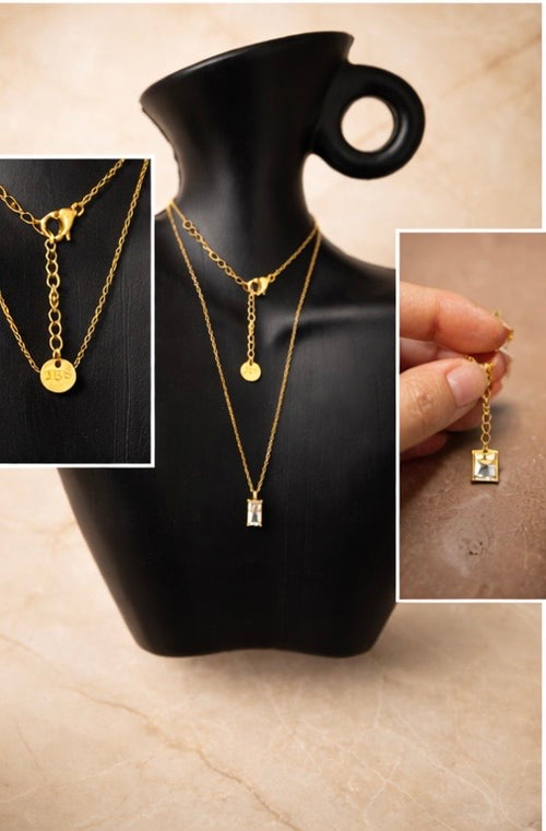 Aura Necklace non-tarnish waterproof gold chain in stainless steel displayed on neutral ceramic dish 