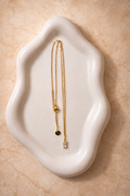 Aura Necklace non-tarnish waterproof gold chain in stainless steel displayed on neutral ceramic dish 