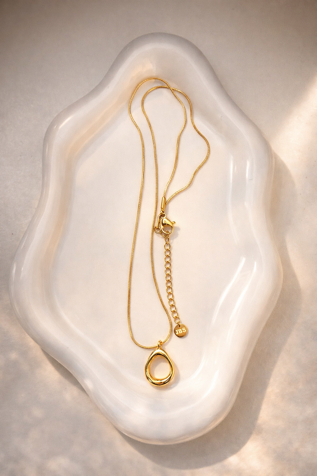 Halo Pendant Necklace non-tarnish waterproof gold pendant in stainless steel displayed on clean flat lay