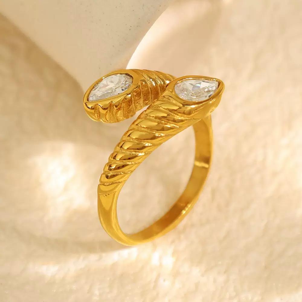 White Emerald Muse Ring non-tarnish waterproof gold ring on a beige background